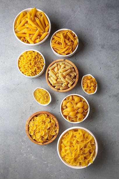 istock Composition with different tasty uncooked pasta - Italian pasta wallpaper, different types and shapes of pasta layout 2249995528