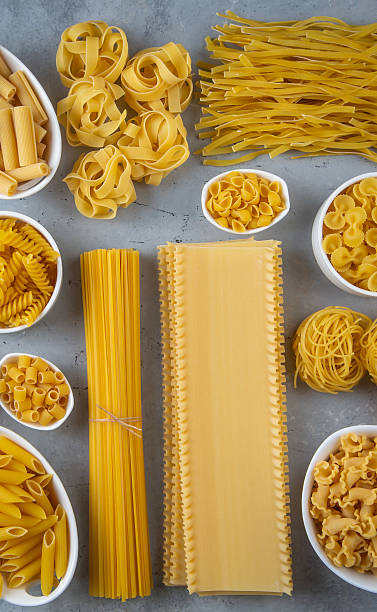 istock Composition with different tasty uncooked pasta - Italian pasta wallpaper, different types and shapes of pasta layout 2249996122