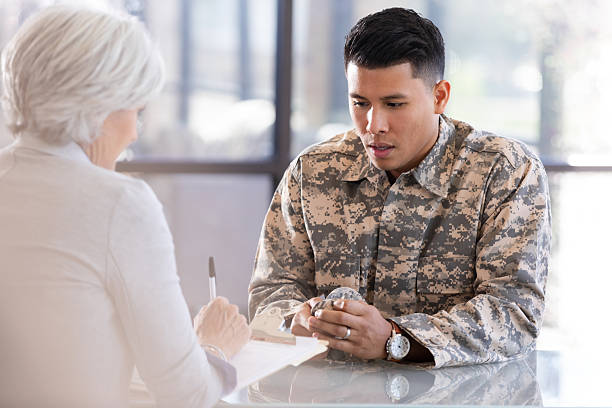 istock Soldier in uniform meets with a therapist for support and counseling indoors. 2249999445