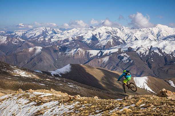 istock Mountain biker rides down alpine slopes, Greater Caucasus Mountains 2250000304