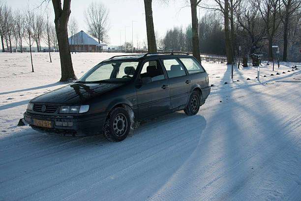 Classic black VW Passat in the snow in the Netherlands. Photo taken in Tiel, the Betuwe, in the Netherlands on 4 February 2012. This item is for editorial use only