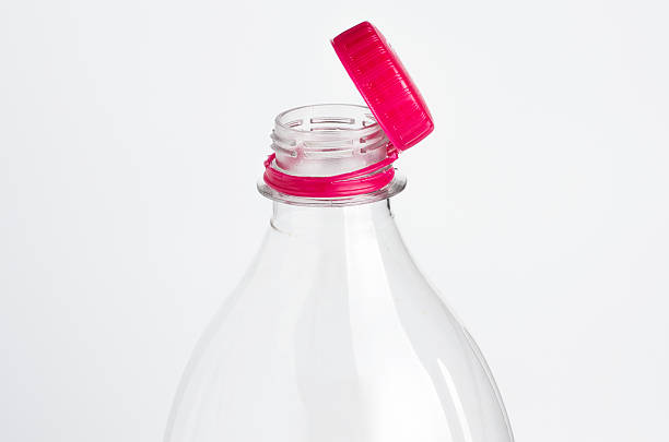 istock Close-up of a clear plastic bottle with a bright pink cap against a white background 2250003621