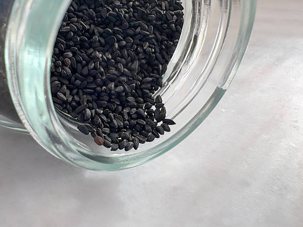 Nigella or black cumin in a jar. Close-up of black sesame nigella in a jar