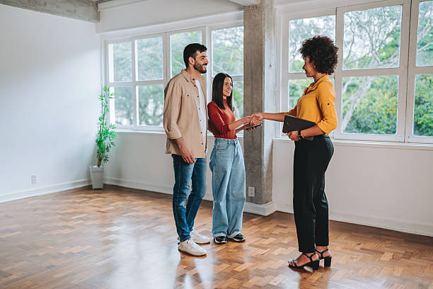 istock Real estate agent greeting couple during apartment visit 2250005013