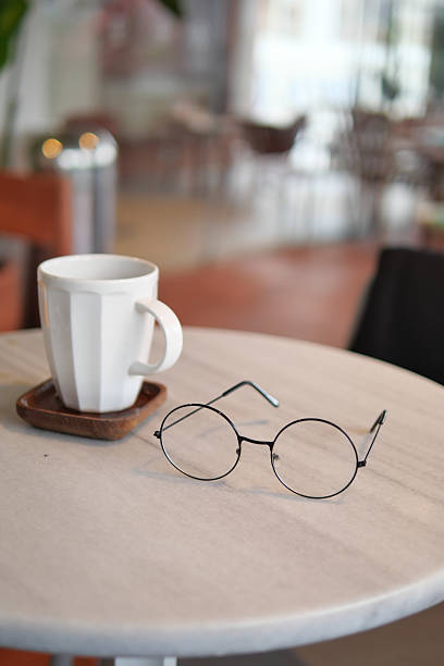 istock Coffee and glasses on a table in a modern cafe 2250005239