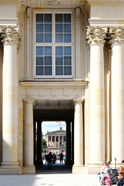 Berlin, Germany, August 24, 2021, view from the inner courtyard of the Humboldtforum through a gate with the Old National Gallery in the background. Berlin, Germany, August 24, 2021, view from the inner courtyard of the Humboldtforum through a gate with the Old National Gallery in the background.
