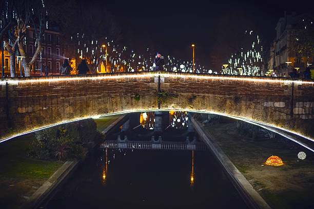 istock Woman Standing on Illuminated Historic Bridge in Perpignan at Night 2250006468