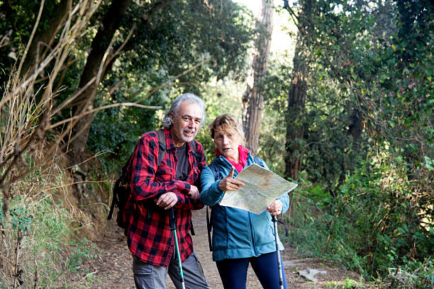 istock Senior couple hiking in forest consulting map 2250007052