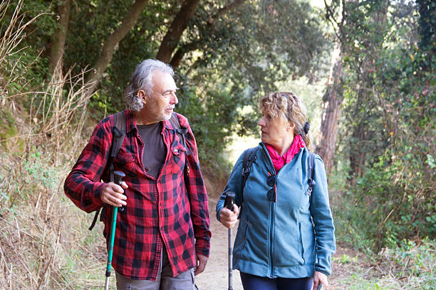 istock Senior couple enjoying active hiking on nature trail 2250007132