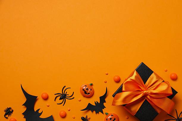 istock Halloween holiday decorations including gift box, pumpkins, spiders, bats on color background 2250008091