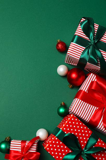istock Beautiful gift boxes tied with bow and decorations on color background 2250008162