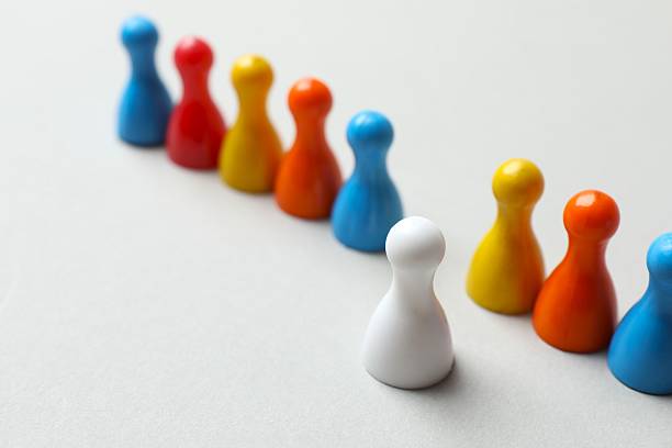 istock Group of color pawns on a light table. 2250008181