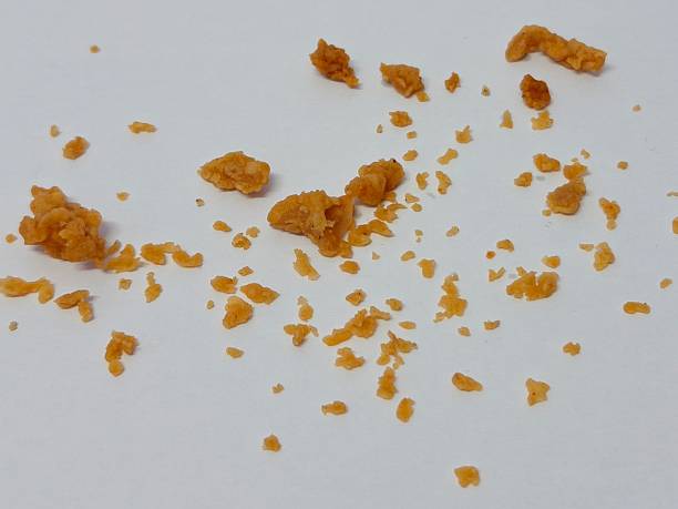 istock Scattered fried chicken batter crumbles isolated on white background 2250009283