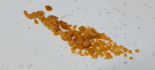 istock Scattered fried chicken batter crumbles isolated on white background 2250009310
