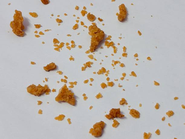 istock Scattered fried chicken batter crumbles isolated on white background 2250009321