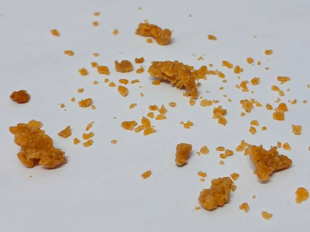 istock Scattered fried chicken batter crumbles isolated on white background 2250009408