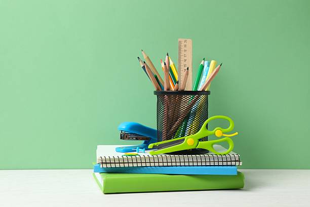 istock Colorful and modern workspace with pencil holder, notebooks and green wall 2250010208