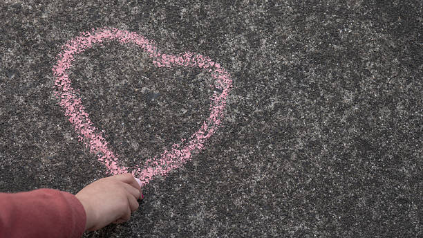 istock Young Girl Drawing Chalk Heart 2250010396