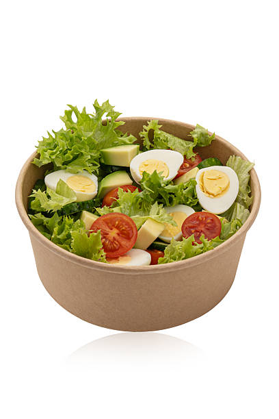 istock Bowl with green salad, avocado and egg isolated on white background 2250011303