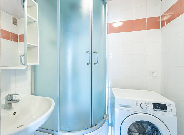 istock Modern Bathroom Interior with Shower, Sink, and Washing Machine Combination 2250012113