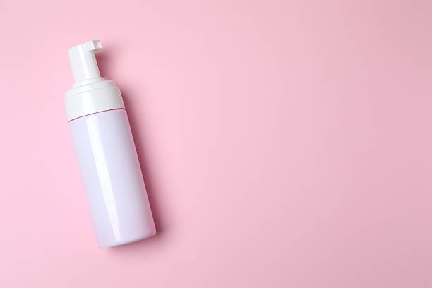istock Cosmetic bottle on a pink background, top view 2250013702