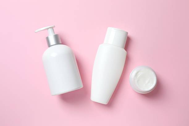 istock Set of cosmetic bottles on a pink background, top view 2250013749