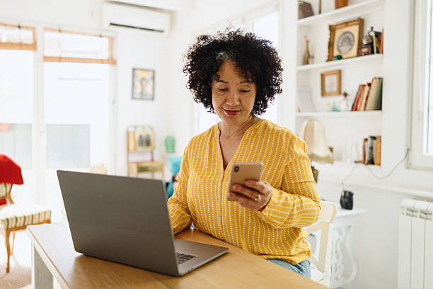 istock Focused Mature Adult Checking Messages While Working from Home Office 2250013806