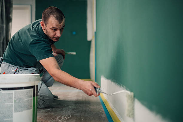 istock Man painting wall with roller during home renovation 2250014522