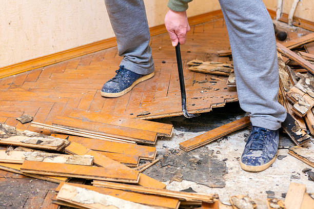 istock A man is dismantling the old parquet on the floor. 2250015010
