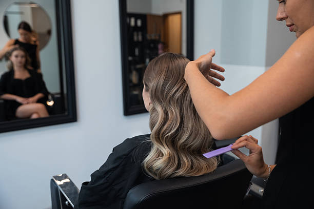 istock Hair styling session at a modern salon with a stylist creating soft waves for a client in a comfortable and relaxing atmosphere 2250018889