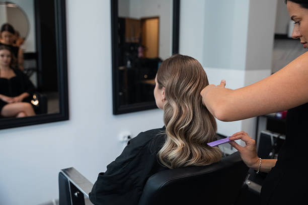 istock Hair styling session at a modern salon with a stylist creating waves for a client 2250018891