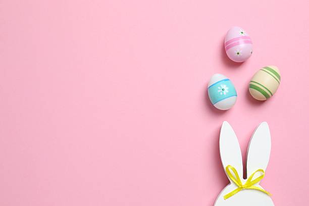 istock Happy Easter. Colorful eggs with bunny ears on color background, space for text or advertising 2250019057