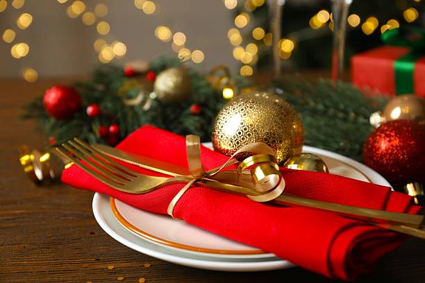 istock Festive Christmas table setting with plate, cutlery and decorations on wooden background 2250019943