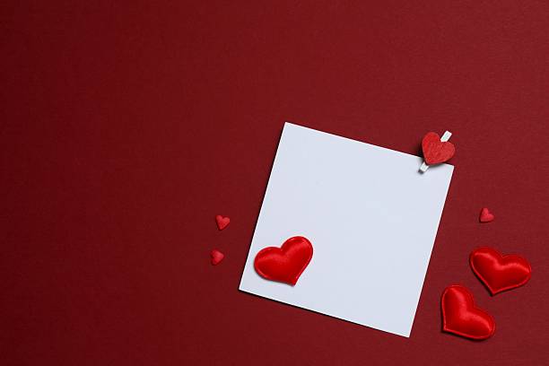 istock Paper card with red hearts on color background 2250020694