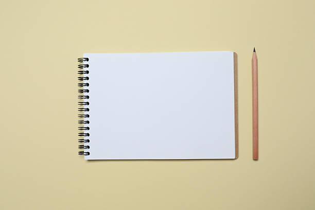 istock Open notebook with a pen on color background, top view 2250020943
