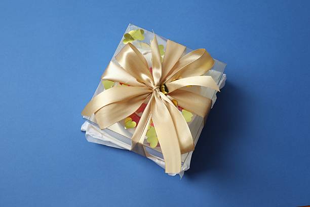 Colorful packaged cake decorated on a colored background