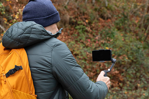 istock Capturing autumn moments on a trail with a handheld camera setup in the woods 2250021781