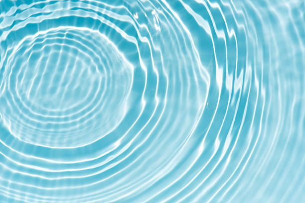 istock Blue water with ripples on the surface. Defocus blurred transparent blue colored clear calm water surface texture with splashes and bubbles. Water waves with shining pattern texture background. 2250023739