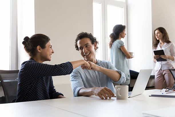 istock Two cheerful office friends celebrating business task completion 2250023844