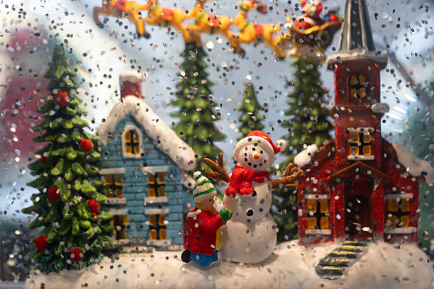 istock Christmas snow globe with snowman and children 2250023922