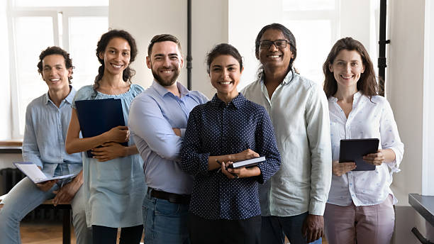 istock Multiethnic confident group of happy employees holding notebooks 2250025261