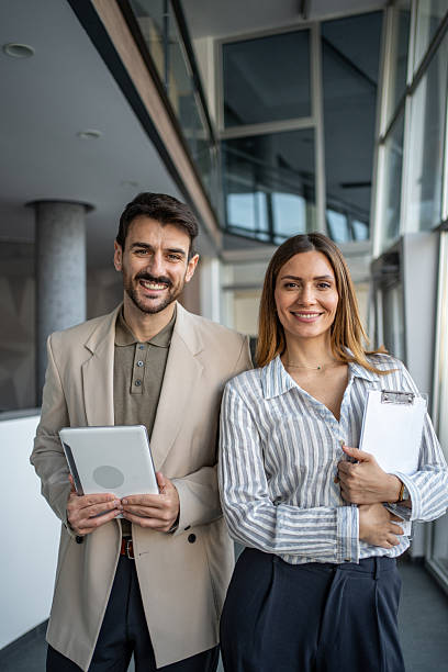 istock Business colleagues standing together in modern office environment 2250025385