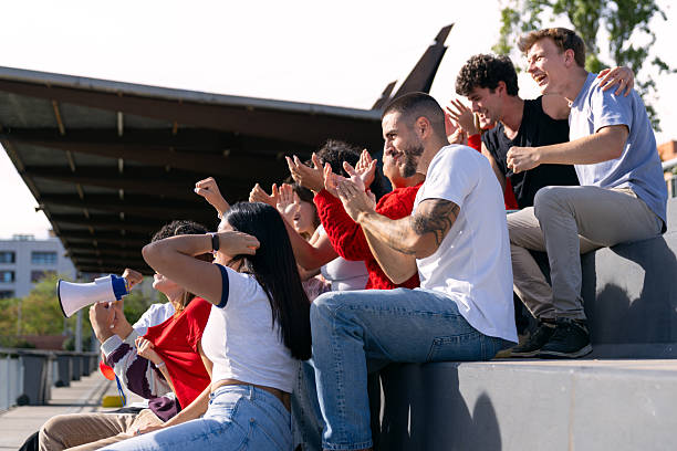 istock Multiethnic friends cheering and celebrating team victory at stadium 2250026267