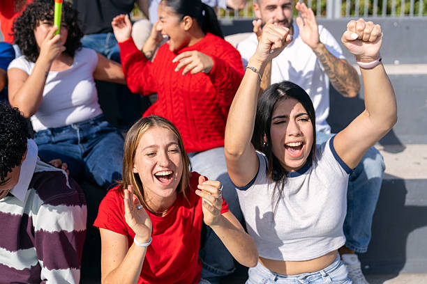 istock Multiethnic group of young adults cheering at a stadium 2250026747
