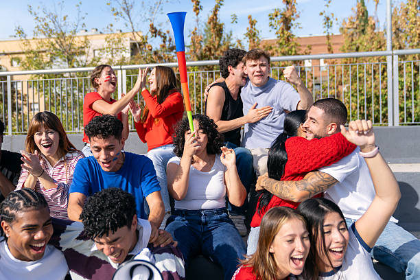 istock Multiethnic sports fans cheering stadium supporting team 2250027287