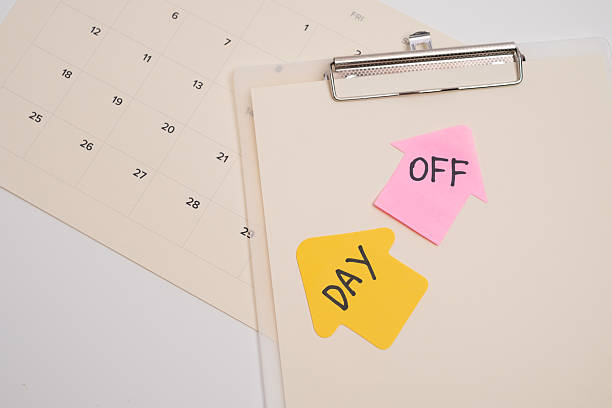 istock Day off reminder on clipboard and calendar. Scheduling a break. 2250028116