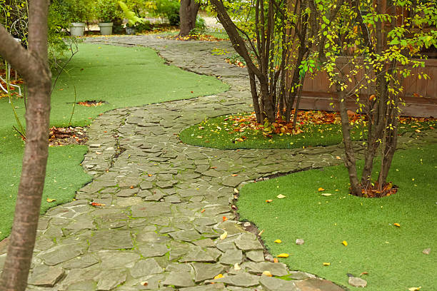 istock Pathway made of stone with greenery on both sides in a garden setting during daytime in autumn 2250029062