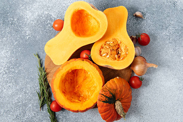 istock Fresh squash and tomatoes on a cutting board with herbs and garlic in a kitchen setting, cleaned of seeds 2250029478