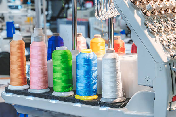 istock Spools of color threads closeup, spinning machine 2250031897