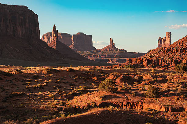 istock Rock formations and desert landscape under blue sky in Monument Valley during sunset 2250033004